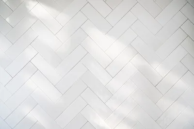 Clean White Herringbone Tile Wall Background