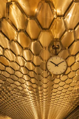 Golden Hexagonal Honeycomb Ceiling With Clock