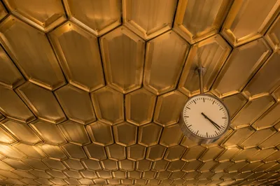 Golden Hexagonal Honeycomb Ceiling With Clock