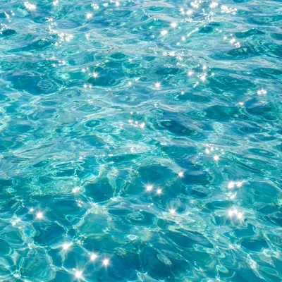 Turquoise Ocean Ripples with Sunlit Sparkles
