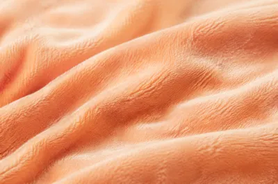 Soft Peach Velvet Texture Background Close-Up
