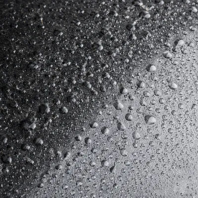 Polished Dark Granite with Condensation Droplets