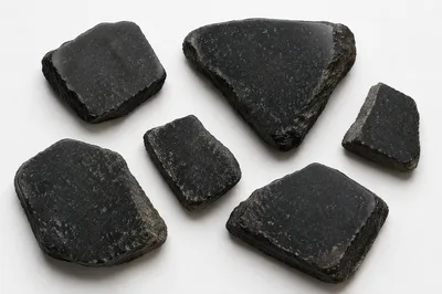 Polished Dark Granite Fragments on White