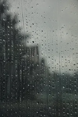 Moody Raindrops on Blurred Window Background