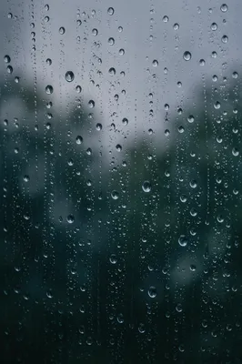 Moody Raindrops on Blurred Window Background