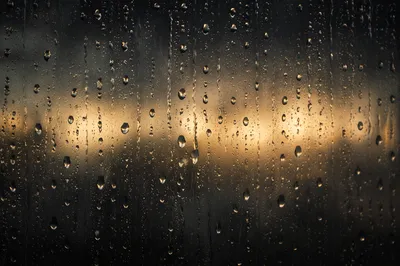 Moody Raindrops on Window Background