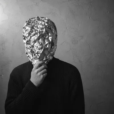 Crumpled Silver Foil Portrait on Gray Plaster