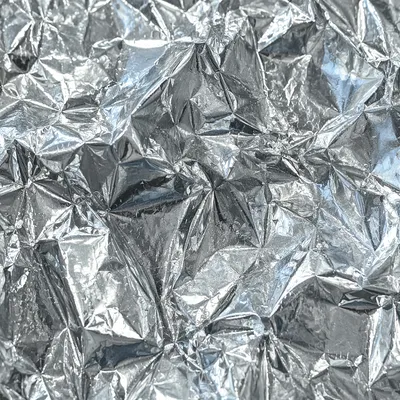 Reflective Crumpled Silver Foil Texture Background