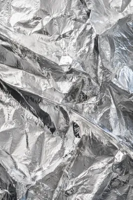 Crumpled Silver Foil Reflective Texture Background