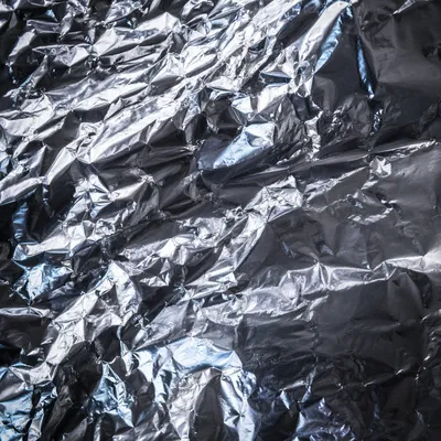 Crumpled Silver Foil Metallic Texture Background