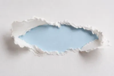 Torn White Paper Revealing Pastel Blue