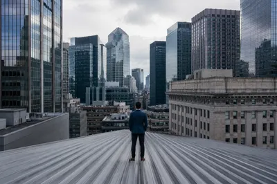 Businessperson Overlooking Urban Office Rooftops