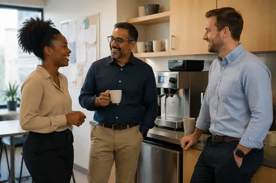 Coworkers Chatting by Office Coffee Machine