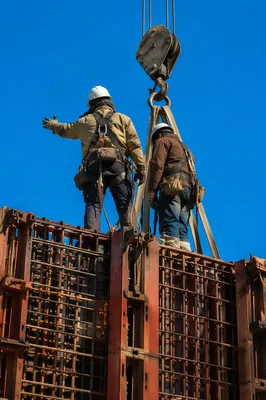 Construction Workers on High Rebar Framework