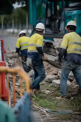 Construction Crew Clearing Roadside Work Zone