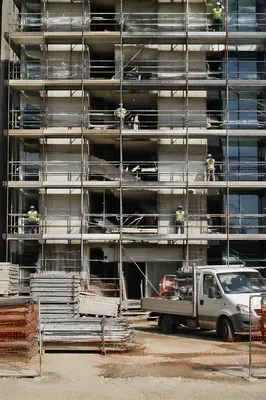 Construction Workers on Urban Scaffolding