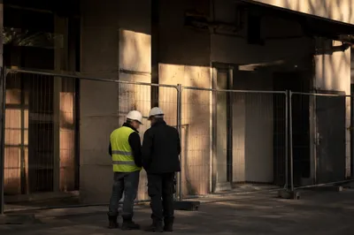 Construction Workers by Urban Safety Fence