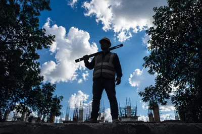 Confident Construction Worker Under Bright Sky