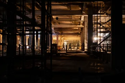 Night Construction Workers in Illuminated Commercial Site