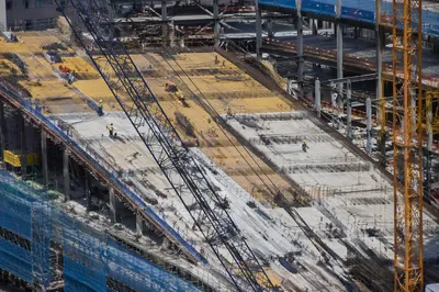 Urban Construction Workers on Concrete Roof Deck