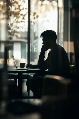 Freelancer in Coworking Cafe by Window