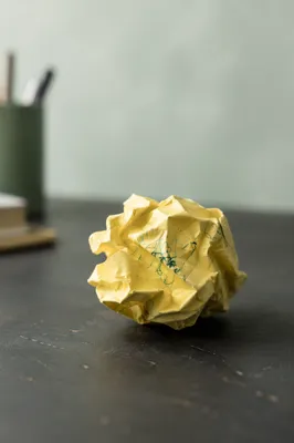Crumpled Yellow Note on Office Desk