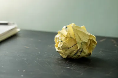 Crumpled Note on Desk for Brainstorming