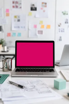 Creative Startup Desk with Magenta Laptop Screen