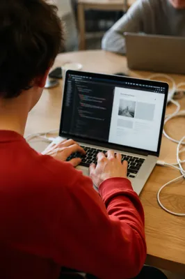 Focused Startup Entrepreneur Coding in Coworking Office