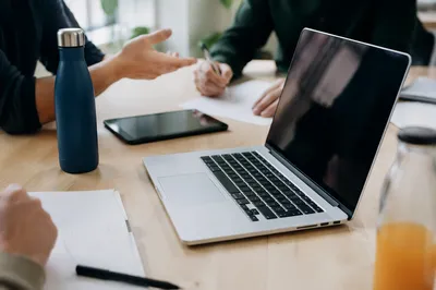 Startup Team Meeting Around Laptop