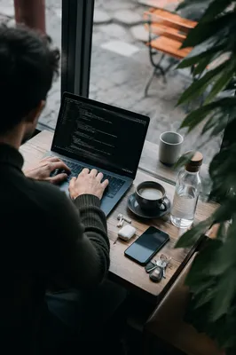 Freelancer Working on Laptop in Cafe