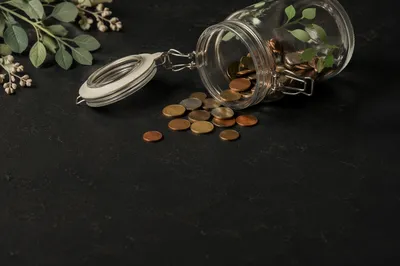 Glass Savings Jar with Coins and Growth