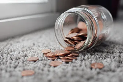 Glass Savings Jar With Spilled Copper Coins