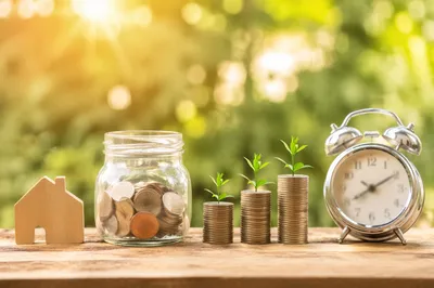 Glass Jar Savings Growth with Coin Sprouts