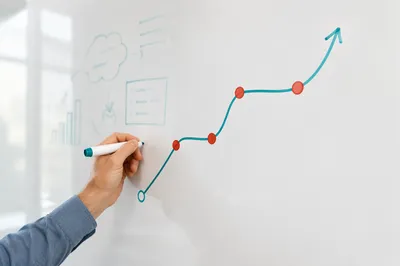 Hand Drawing Business Flowchart on Whiteboard