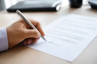 Hand Signing Business Contract With Pen