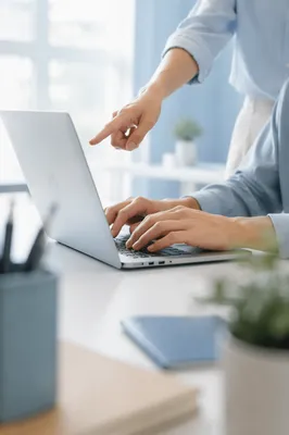 Hands Collaborating Over Office Laptop