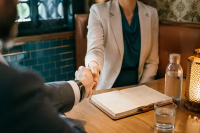 Professional Handshake Agreement in Cozy Café