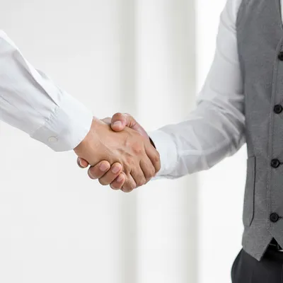 Professional Handshake Agreement in Bright Office
