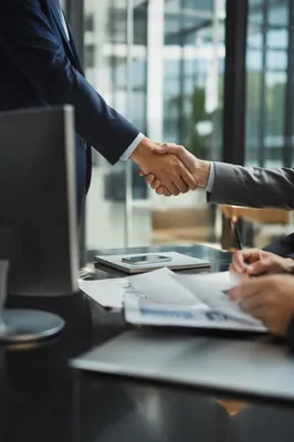 Professional Handshake in Modern Office Meeting