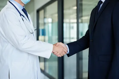 Healthcare Partnership Handshake in Modern Office