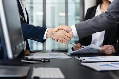Professional Handshake in Modern Office Meeting