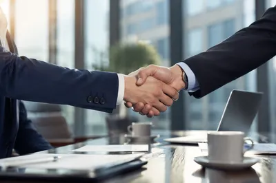 Professional Handshake in Modern Office Meeting