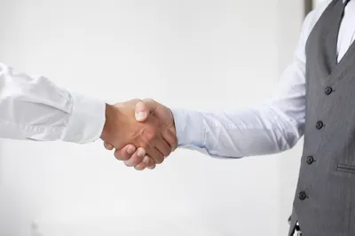 Professional Handshake Agreement in Bright Office