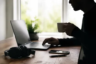 Focused Workspace With Headphones and Laptop