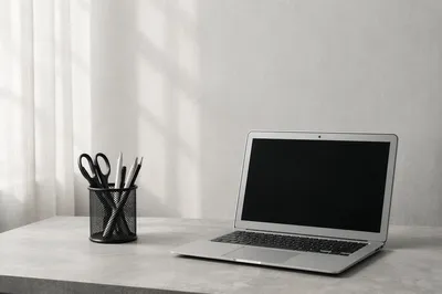 Minimal Laptop Workspace on White Desk