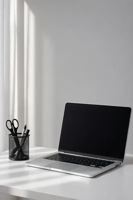 Minimalist Laptop Workspace on White Desk