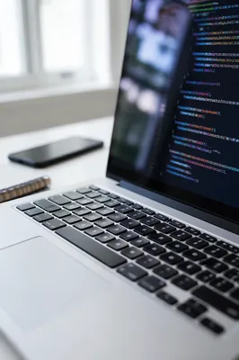Developer Laptop With Code On Modern Desk