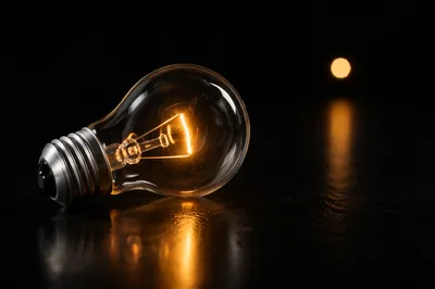 Glowing Lightbulb on Dark Business Background