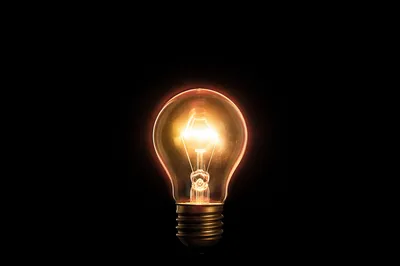 Glowing Lightbulb Business Idea on Black